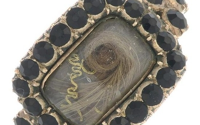 A late Georgian gold, garnet memorial ring.Ring size S.