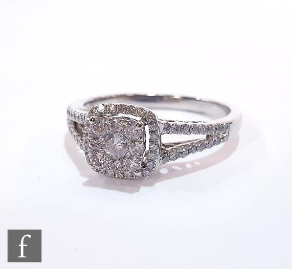 A modern 9ct hallmarked white gold diamond cluster ring, cen...