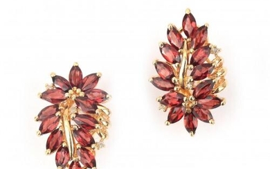 A pair of 14 karat gold garnet earrings. In the design of a leaf featuring marquise cut garnets. French fitting (stud and clip). Gross weight: 9.8 g.