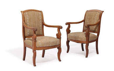 A pair of 19th century mahogany Charles X armchairs, carved with foliage, curved armrests. (2)
