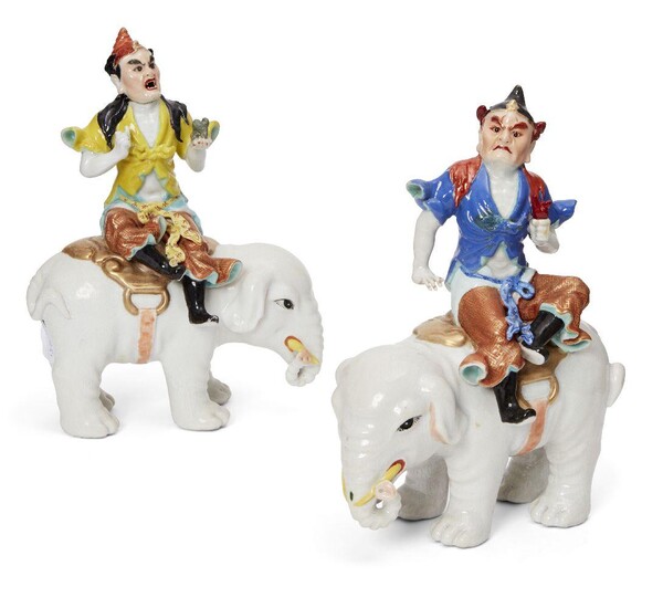 A pair of Chinese famille rose and gilt-decorated porcelain figures on elephants, 18th century, each moulded as a tribute bearer seating sideways on a white elephant, 23.5 cm high (2)