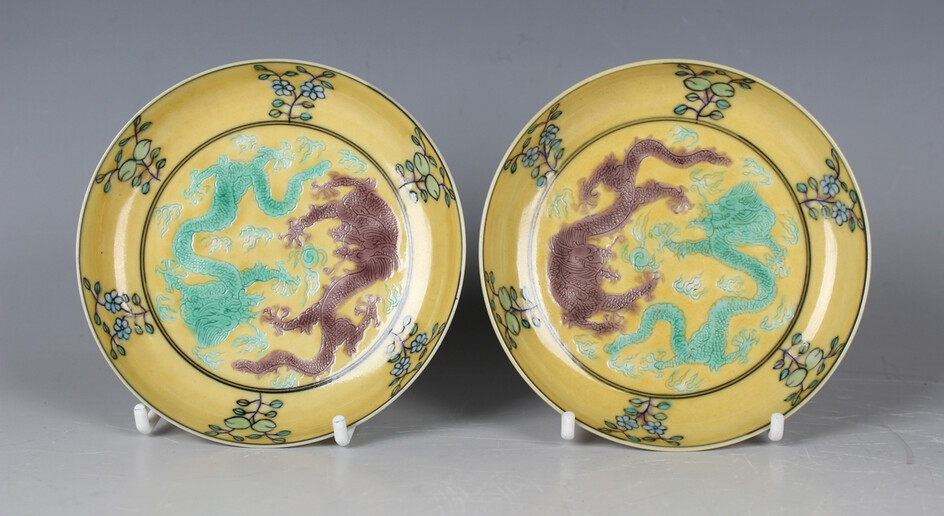 A pair of Chinese famille verte yellow ground enamelled biscuit porcelain saucer dishes, mark of Gua