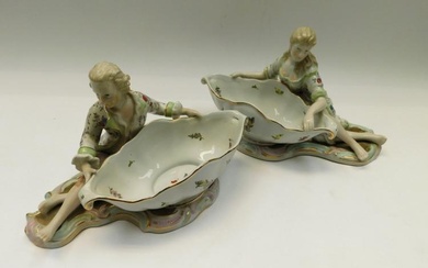 A pair of Continental porcelain sweet meat dishes with figures...