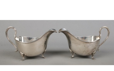 A pair of George V silver sauceboats, raised on three feet. ...