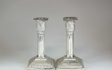 A pair of Victorian silver mounted candlesticks
