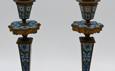 A pair of candlesticks made of enameled brass with...
