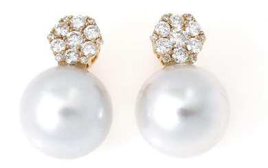 A pair of pearl earrings each set with a cultured South Sea...
