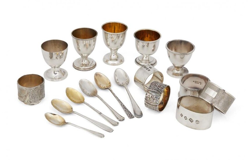 A quantity of silver eggcups and napkin...