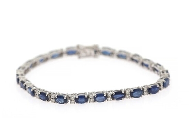 A sapphire and diamond bracelet set with numerous sapphires and diamonds, mounted in 14k white gold. L. 18.5 cm.