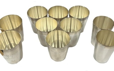 A set of six German metalwares silver stacking shot cups together with a further two pairs