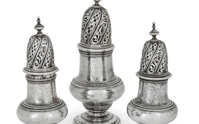 A set of three George II silver casters, London, 1743, Elizabeth Godfrey, of baluster form, with pierced domed lids surmounted with knopped finials, the larger example 20.5cm high, approx. 13.6oz, the two smaller examples 17cm high, all three...