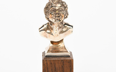 A silver-plated bust of a Bacchanalian Fawn by Omar Ramsden, modelled leaning forward, on oak