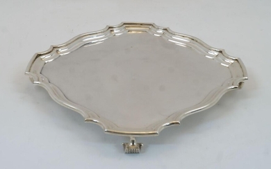 A silver salver, London, 1912, Horace Woodward & Co Ltd, of shaped square form on four scroll feet, 26.5cm wide, 26.5cm deep, weight approx. 24.5oz