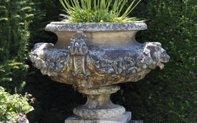 A stone composition garden urn on plinth, in Edwardian taste