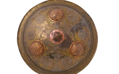 AN INDIAN BRASS DHAL SHIELD WITH A LARGE COPPER SPIKE,...
