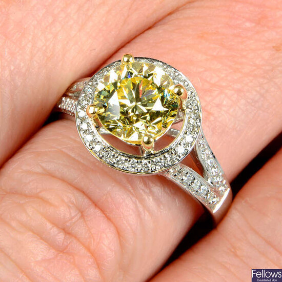 An 18ct gold brilliant-cut 'yellow' diamond and diamond ring.