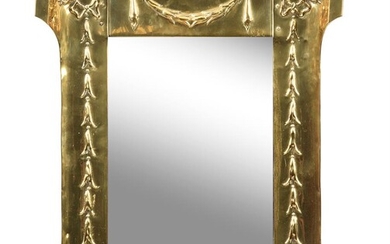 An Art Nouveau brass framed wall mirror