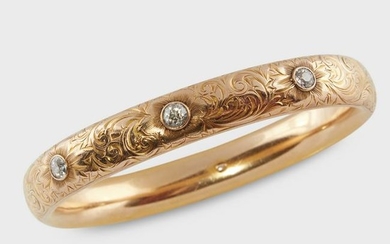 An Art Nouveau diamond and fourteen karat gold bangle