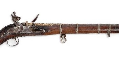 An East India Company Afghan flintlock jezail musket, early 19th century, the lock plate with East India lion mark, the stock with foliate carving and mother-of-pearl inlaid decoration, the octagonal watered steel barrel with Damascene decoration...