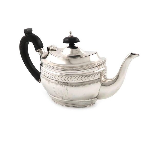 An Edwardian silver bachelor~s teapot, by Nathan and Hayes, Chester 1904, oval form, scroll handle, engraved decoration, length handle to spout 21.5cm, approx. weight 9oz.
