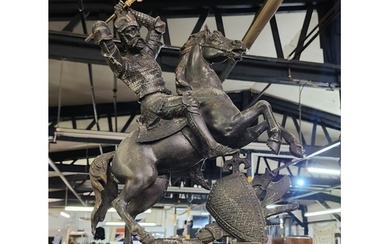 An antique metal sculpture of a fighting warrior on horse b...