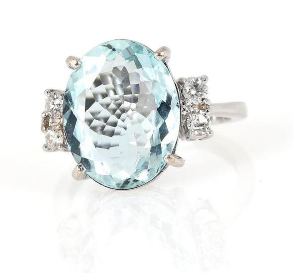 An aquamarine and diamond ring set with an oval-cut aquamarine weighing app....