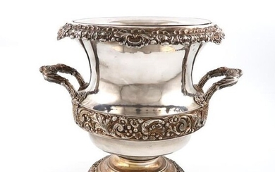 An early 19th century old Sheffield plated wine cooler, circa 1830, campana form, embossed foliate scroll decoration, leaf capped side handles, foliate scroll borders, with a liner, on a raised circular foot, height 24cm.
