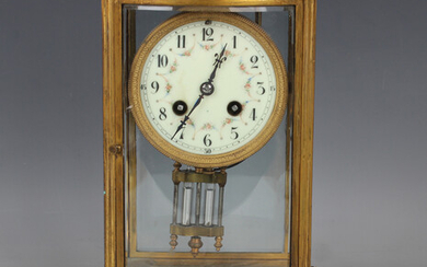 An early 20th century French gilt brass and mahogany four glass mantel clock with eight day movement