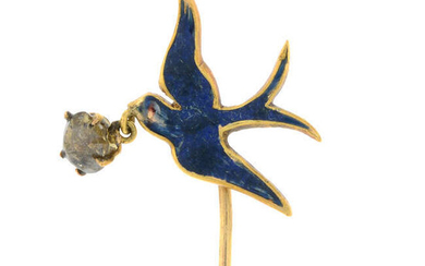 An early 20th century gold and blue enamel swallow stickpin, suspending a rose-cut diamond drop.