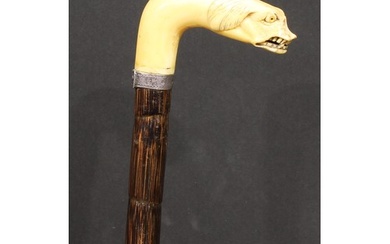An early 20th century novelty walking stick, the faux-ivory ...