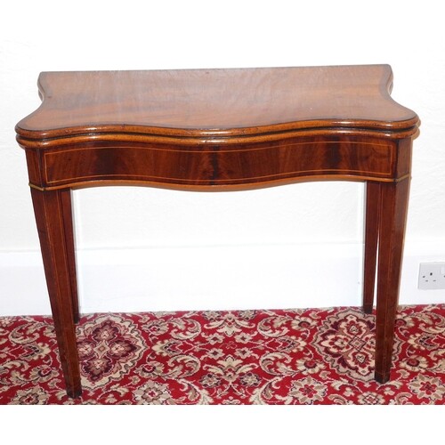 An early George III mahogany serpentine fronted tea table, c...