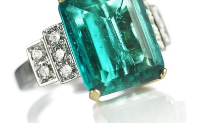 An emerald and diamond ring set with a Colombian emerald weighing app. 5.87 ct. flanked by diamonds weighing app. 0.66 ct., mounted in 18k white gold.