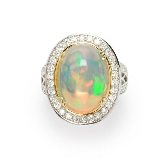 An opal, diamond and fourteen karat white gold ring