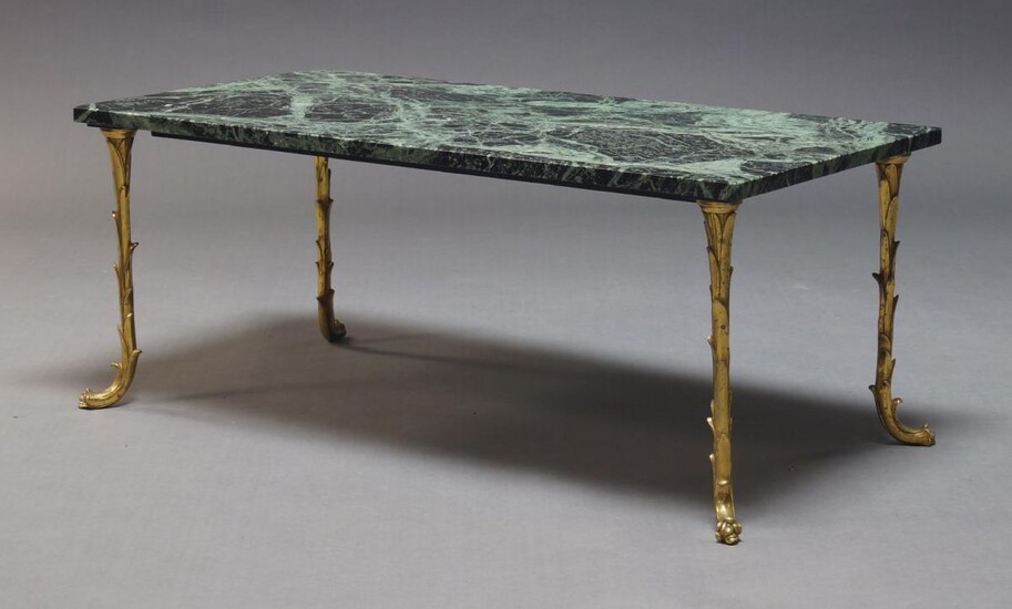 Attributed to Maison Bagués, a marble top and brass coffee table, c.1960, the rectangular variegated green marble top on leaf motif legs to floral feet, 40cm high, 100cm wide, 50cm deep