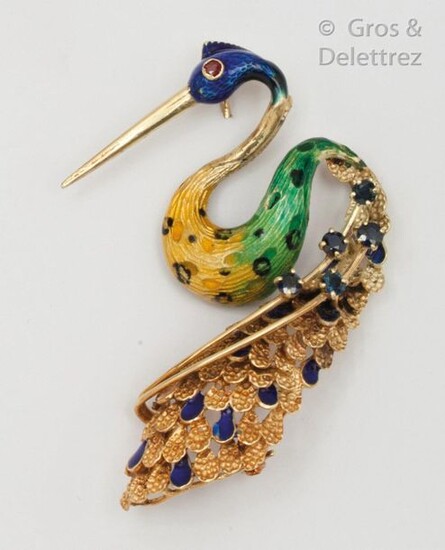 Bird of Paradise" brooch in 14K yellow gold partially enamelled green-yellow and blue, set with sapphires and a ruby eye. Dimensions: 3.7 x 6.7cm. Gross weight: 24.9g.