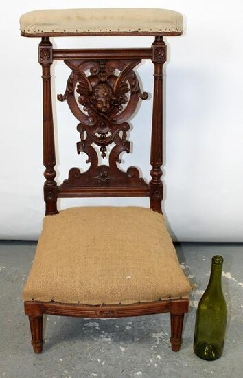 French carved walnut prayer chair with cherub