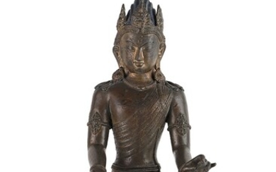 Népal, vers 1900 Élégante sculpture en bronze partiellement doré représentant une divinité assise en dianasana...