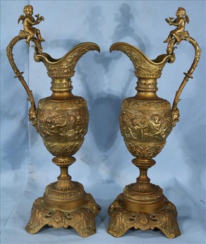 Pair of Victorian bronze ewers with cupids, 25 in. T.