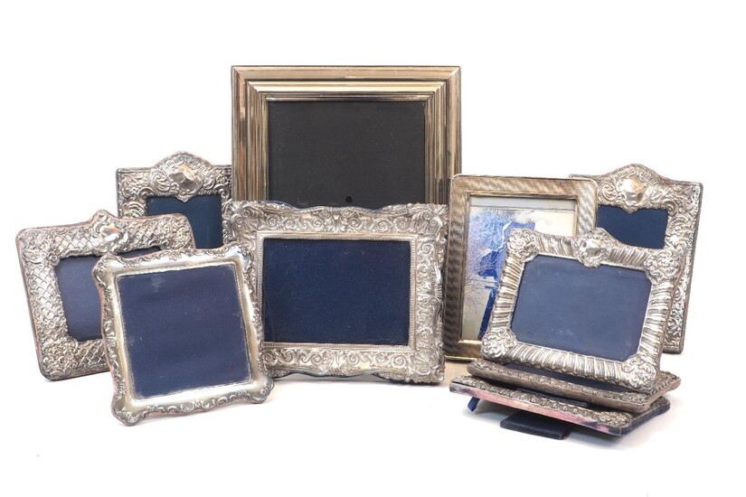 Seven silver mounted photo frames including three examples by Carrs of Sheffield and three examples of matching lobed design, Birmingham, c.1993, SF Ld., together with a large white metal frame and a further two silver plated examples, several...