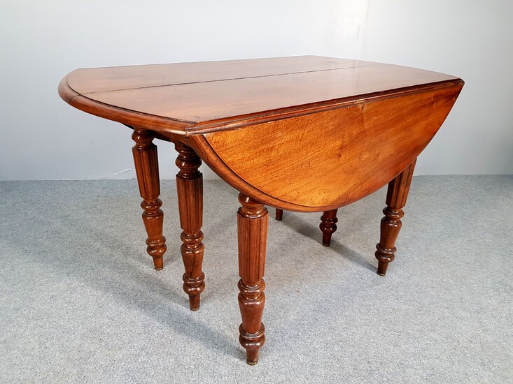 Six legs walnut table with two flaps forming a round...