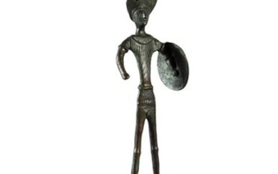 Statuette of an Etruscan warrior, wearing a helmet with a crest and holding a shield in his left hand.