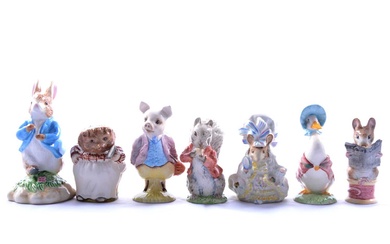 Twelve Beatrix Potter figures.