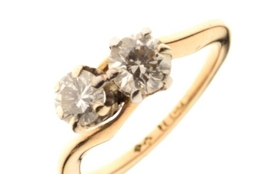 Two stone diamond crossover ring, the yellow mount stamped...