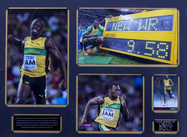 USAIN BOLT SIGNED PHOTOGRAPH mounted in a display with...