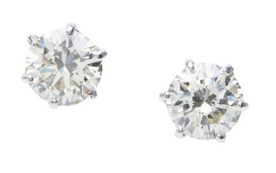 A PAIR OF DIAMOND STUD EARRINGS - Each round brilliant cut diamond weighing 1.12cts, claw set in 18ct white gold.