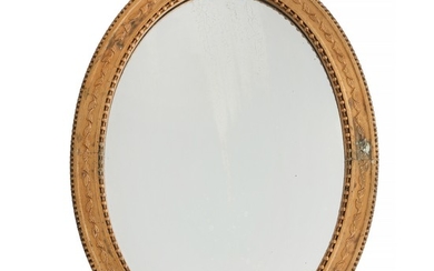 An oval Empire giltwood and gilt gesso mirror. Ca. 1820. H. 75 cm. W. 57 cm.