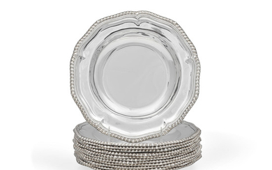 A set of Twelve English silver soup plates