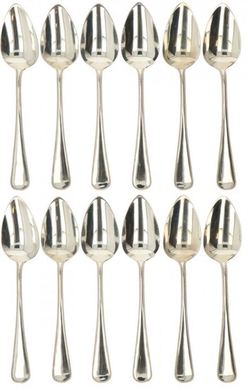 A (12) piece set of silver dinner spoons.