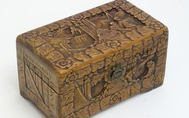 A 20thC Chinese carved camphor wood hinged box