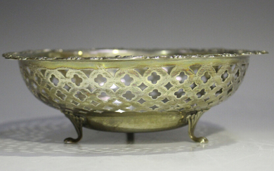 A Birks sterling circular bowl cast with foliate scroll rim above pierced lattice sides, on foliate